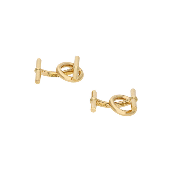 Mancuernillas estilizadas firma Hermes en oro amarillo 18 kilates.