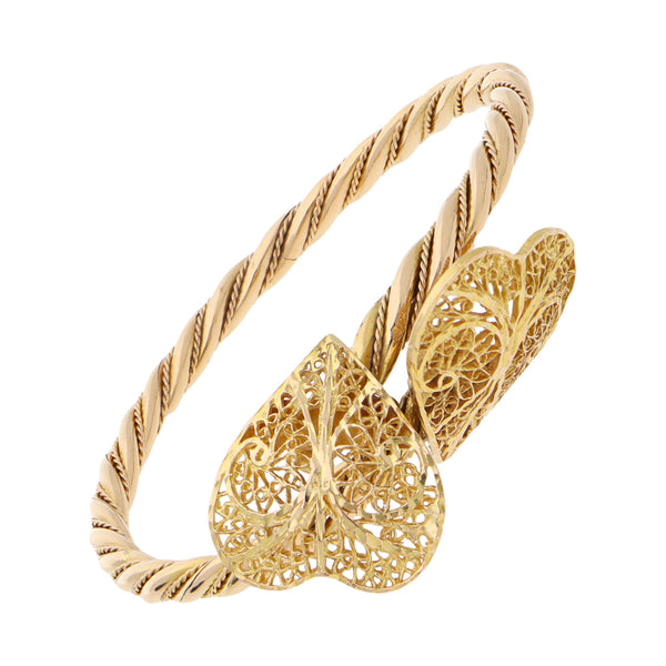 Pulsera de arillo torzal con aplicaciones motivo corazón en oro amarillo 18 kilates.